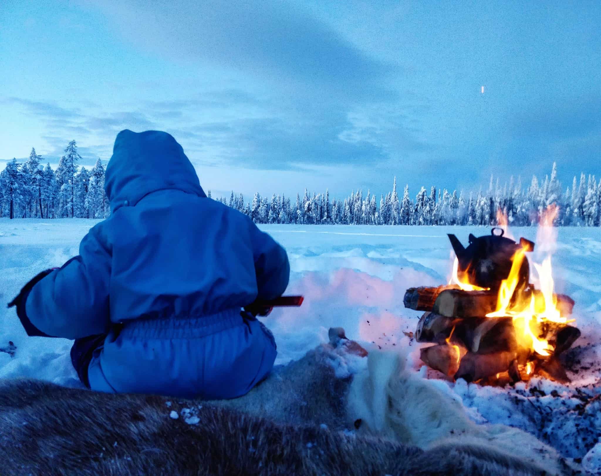 Family by a campfire in the snow